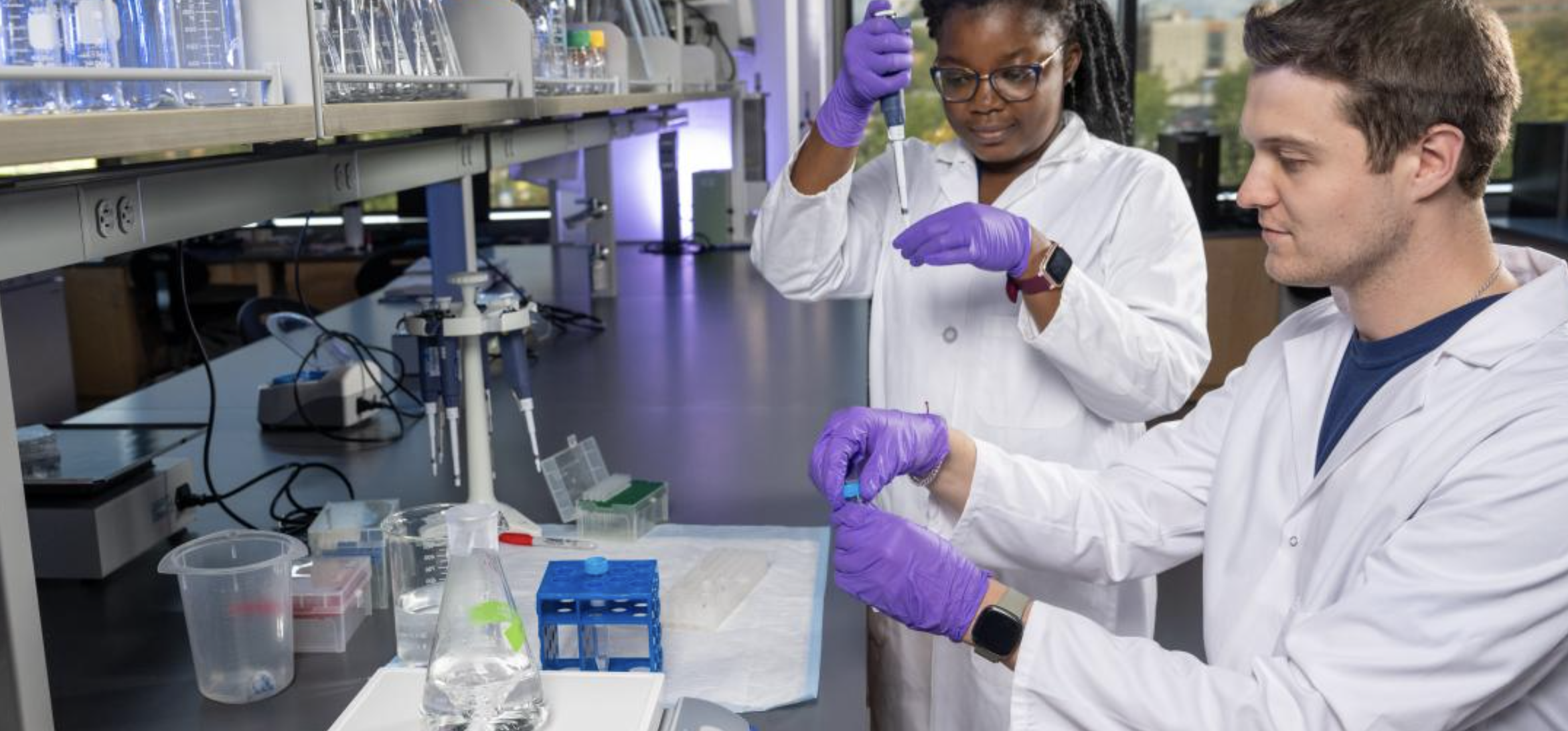 Two Students working with pipettes