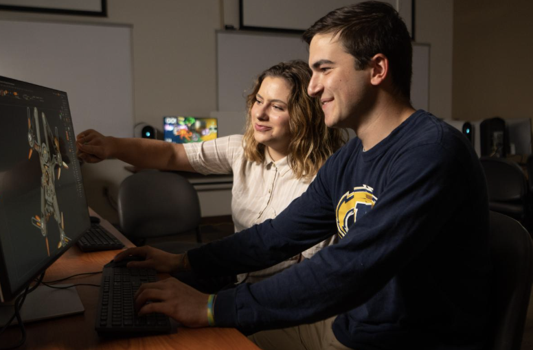 Two students look at a computer