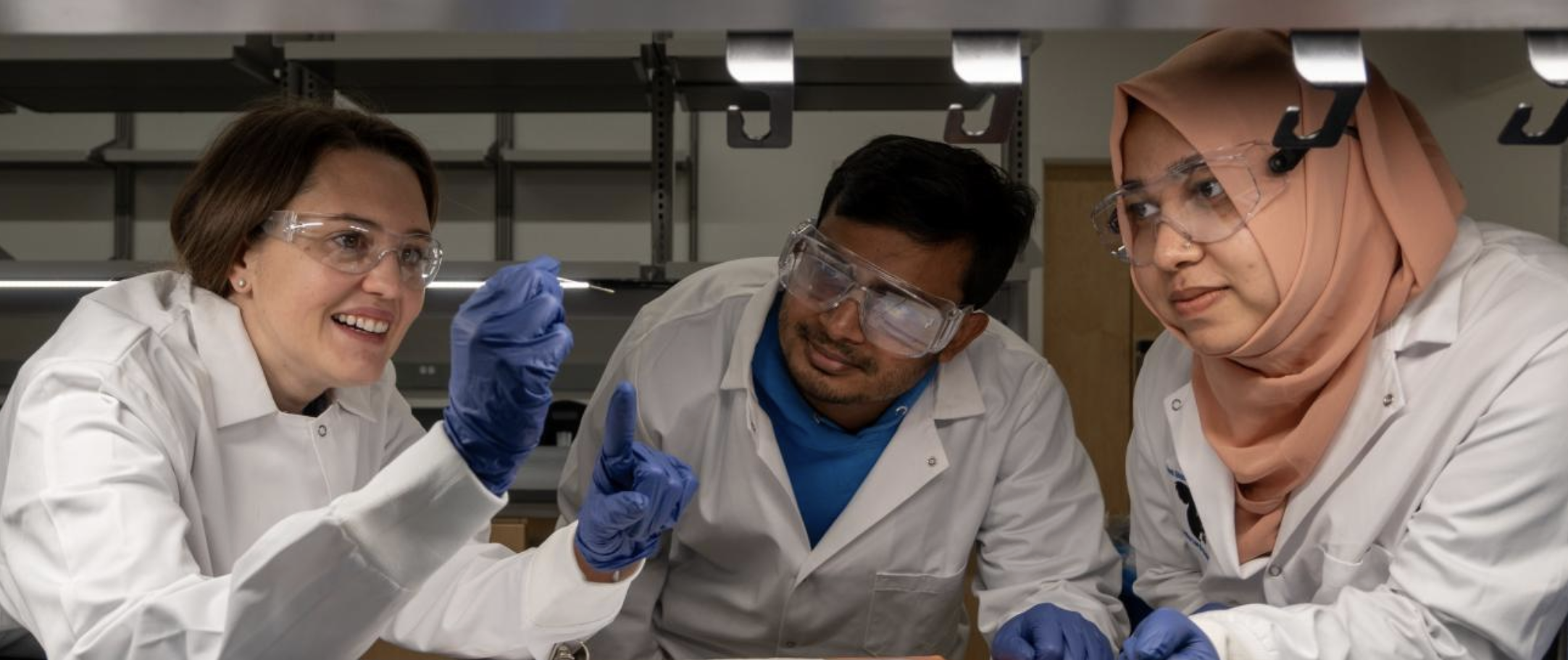 Teacher shows results to two students