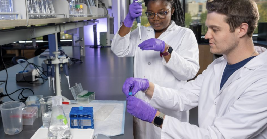 Two students fill pipettes